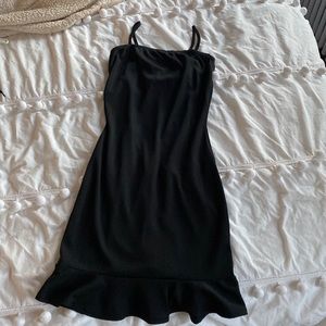 Black bodycon midi dress with drop hem ruffle at the bottom